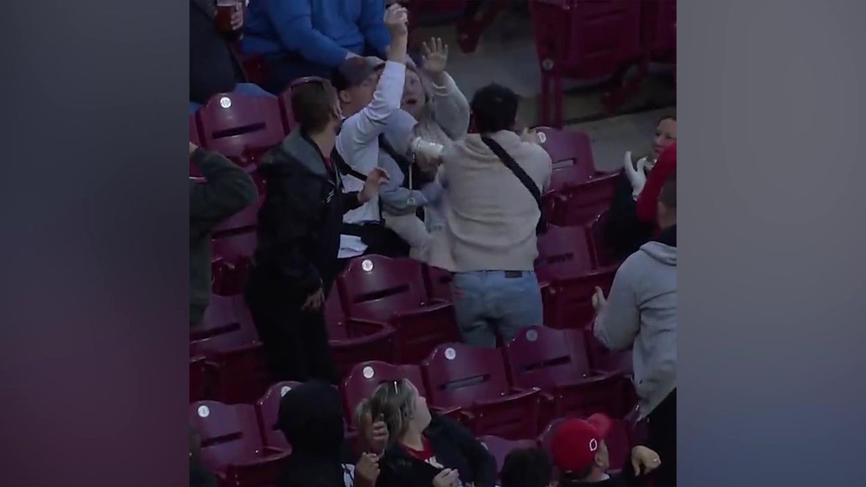 'Father of the year' catches foul ball while bottle-feeding baby