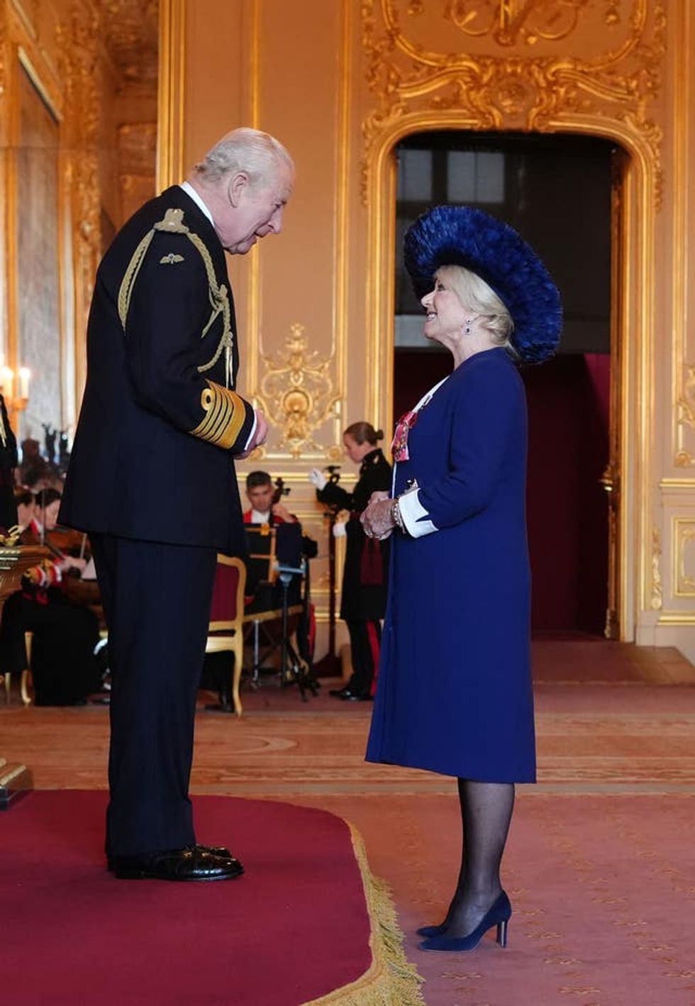 Dame Elaine Paige receiving her damehood from the King at Windsor Castle