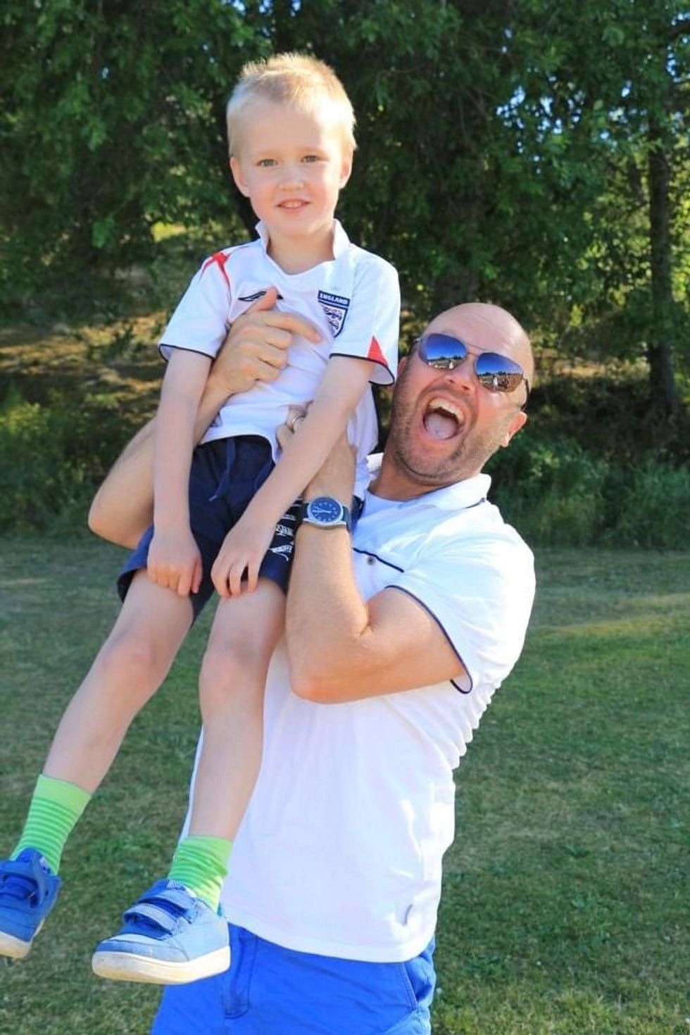 Damion Potter poses with one of his Swedish wife's family members, wearing England football shirts.