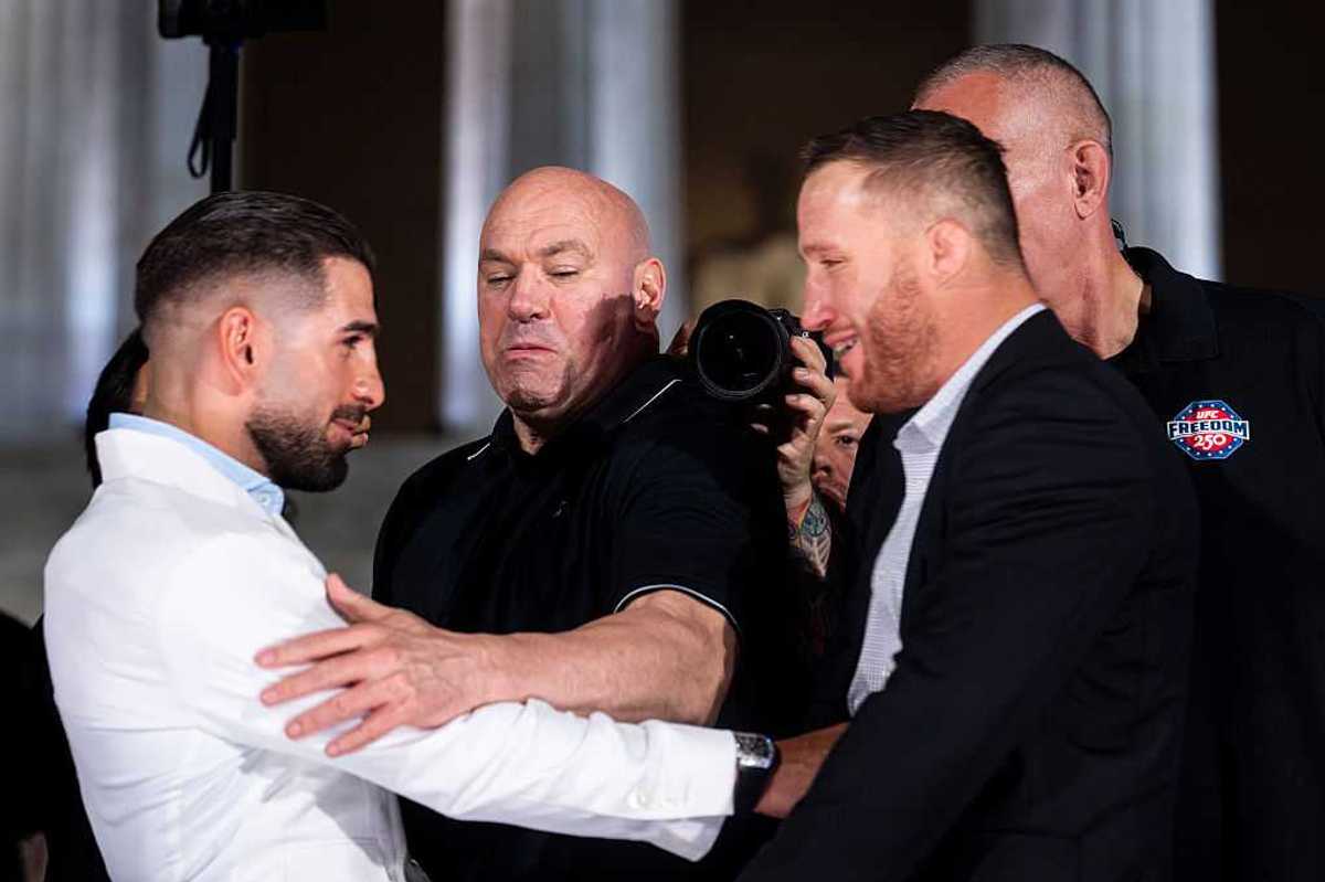 Dana White separates lightweight fighters Ilia Topuria and Justin Gaethje as Topuria shoves Gaethje during their face off at a press conference at the Lincoln Memorial.