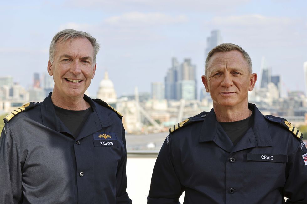 Daniel Craig, wearing the honorary Royal Navy rank of commander, with First Sea Lord Admiral Sir Tony Radakin, left (LPhot Lee Blease/PA)
