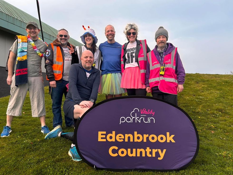 Darren Wood wearing a T-shirt and a tutu in a group of people at Edenbrook Country parkrun