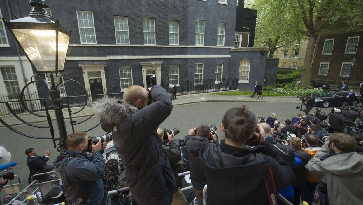David Cameron arrives at Downing Street on Friday morning with his wife Samantha