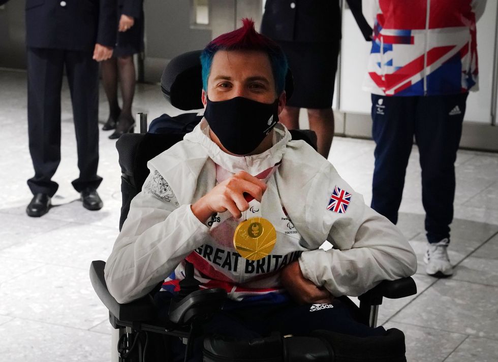 David Smith arrives at Heathrow Airport with the gold medal he won in the Tokyo 2020 Paralympic Games (Steve Parsons/PA)