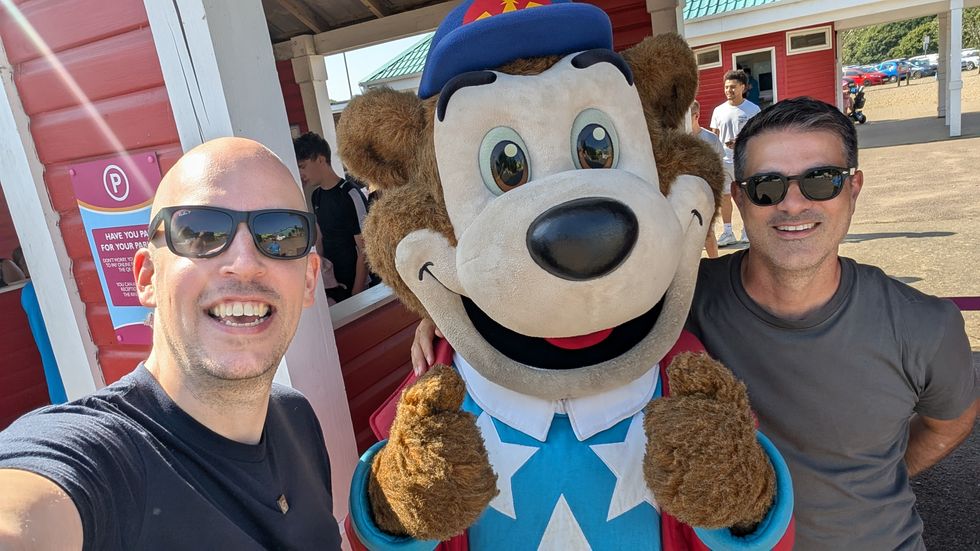Dean Stokes (left) and friend Simon Fasolo (right) pose with a theme park mascot
