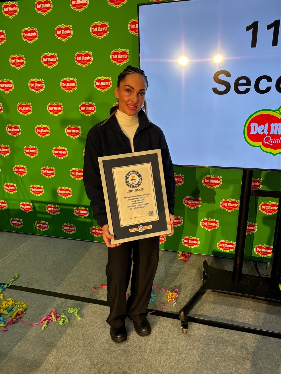 Del Monte factory worker Dominika Gasparova, who peeled and sliced a pineapple in 11.43 seconds - and is now the Guinness World Records title holder. (Sam Russell/ PA)