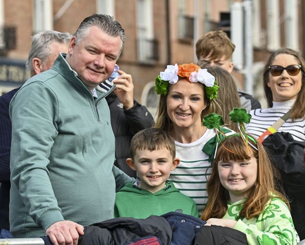 Derek, Eoin, Paula, and Emma Donnelly, from Dublin wait for the St Patrick\u2019s Day Parade in Dublin.