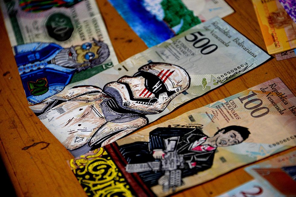 Devalued Bolivar bills painted by Venezuelan illustrator Jose Leon at his workshop in San Cristobal, Venezuela on 2 February 2018. (Picture: