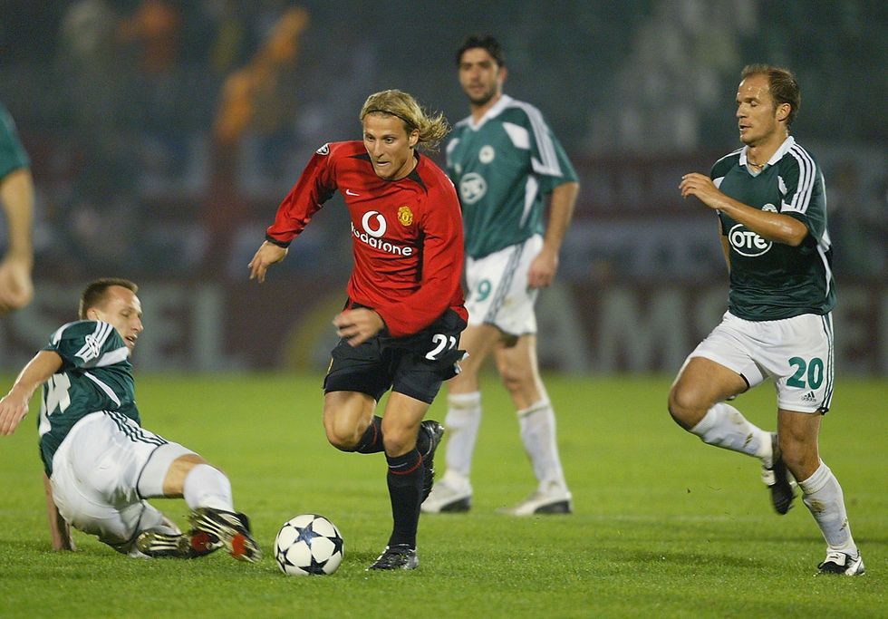 Diego Forlan of Manchester is challenged by Angelos Basinas of Panathinaikos during the UEFA Champions League Group E match between Panathinaikos and Manchester United at Apostolos Nikolaidos Stadium on November 26, 2003 in Athens, Greece