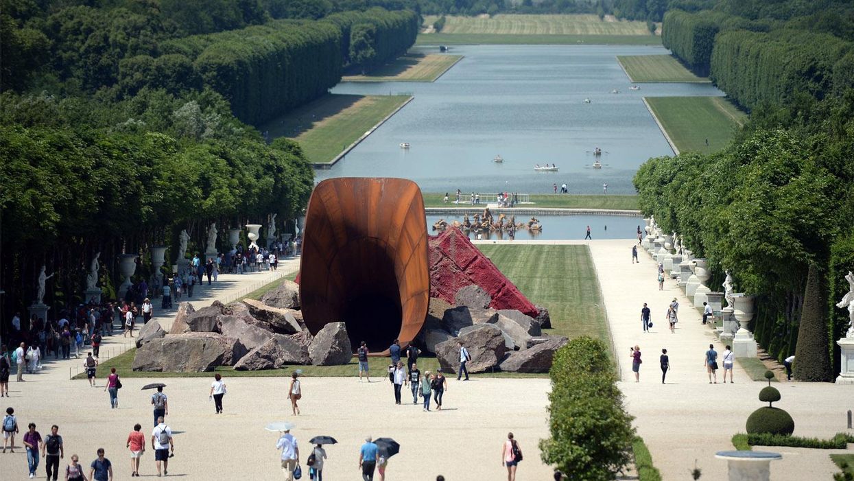 'Dirty Corner', a 2011 Cor-Ten steel, earth and mixed media monumental artwork by British contemporary artist of Indian origin Anish Kapoor, is displayed in the gardens of the Chateau de Versailles, in Versailles on 5 June 2015