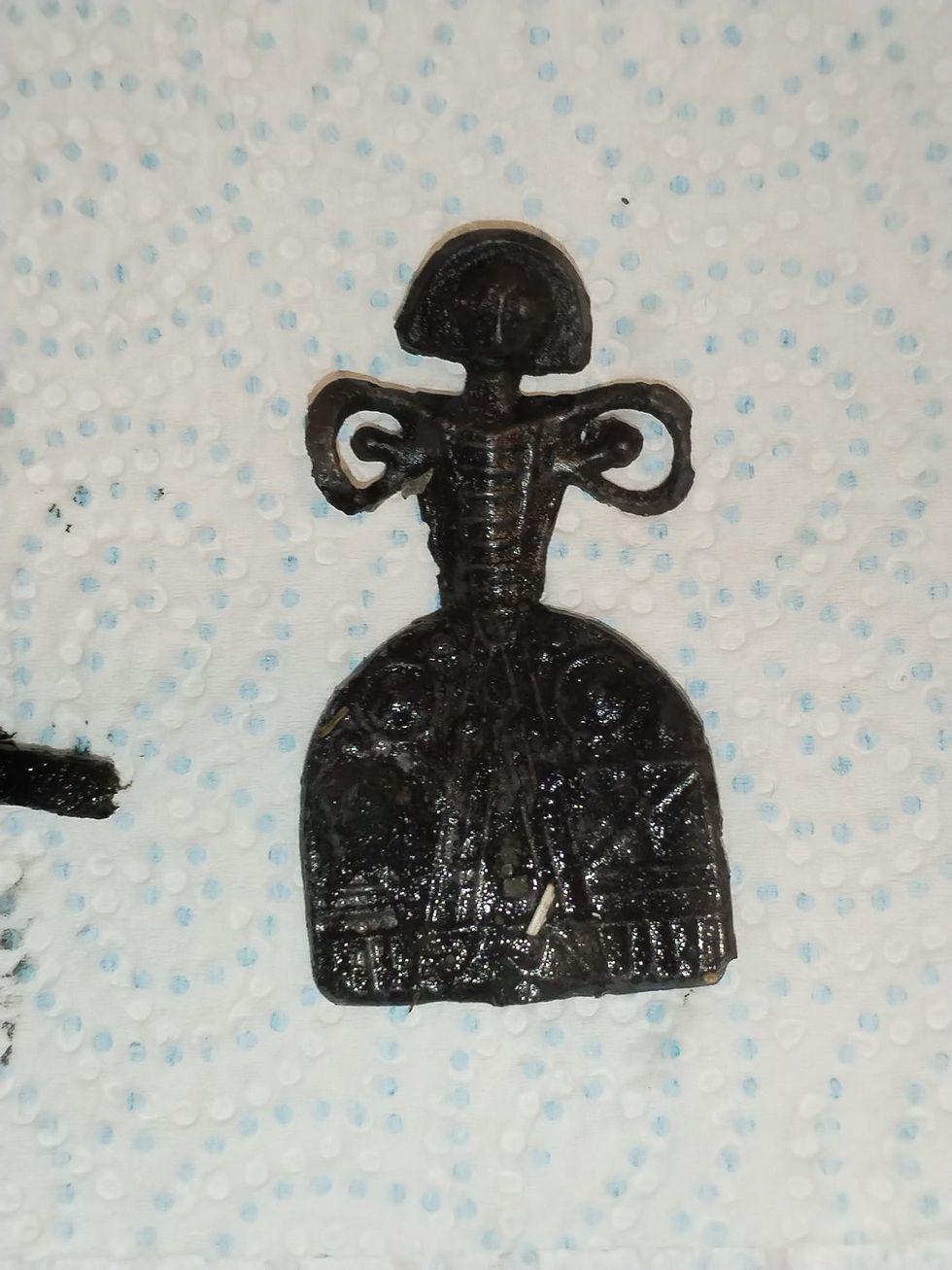Doll on a piece of toilet roll