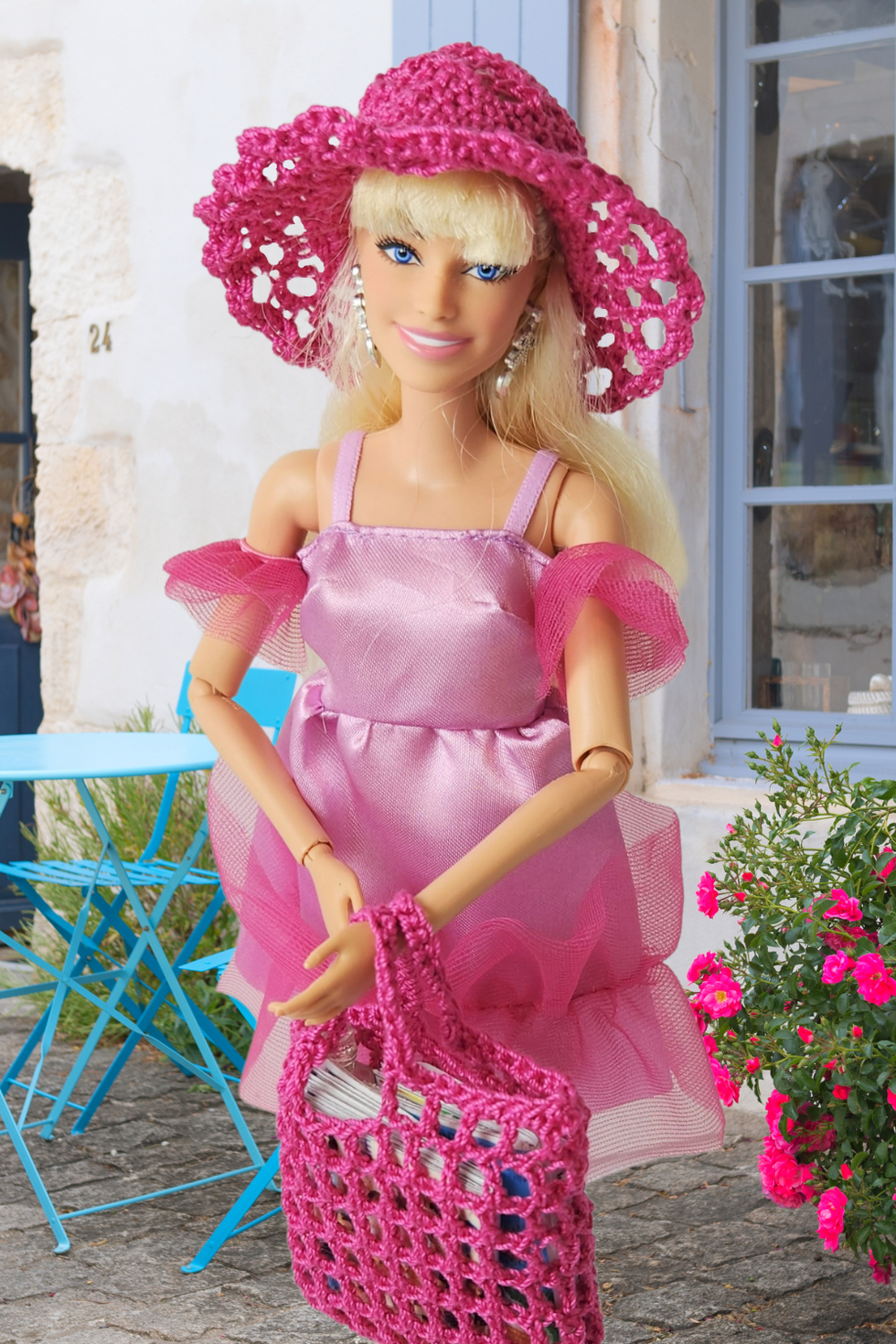Doll wearing crocheted hat and bag