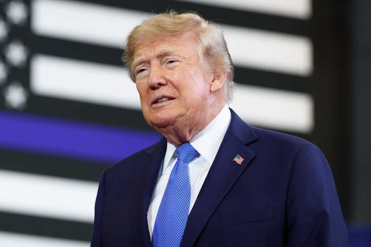 Donald Trump, a white man with short blonde hair and a navy suit.