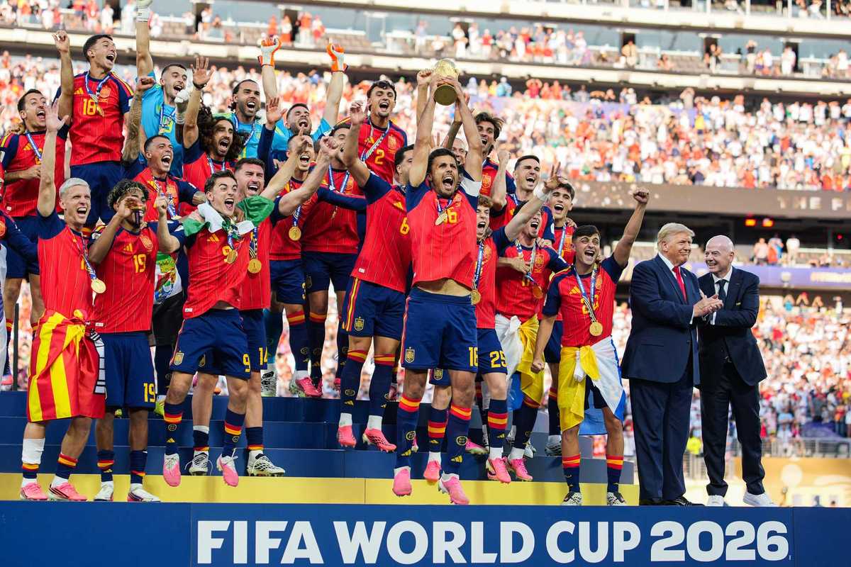 Donald Trump and Gianni Infantino on stage with the Spanish men's football team as they lift the World Cup trophy.