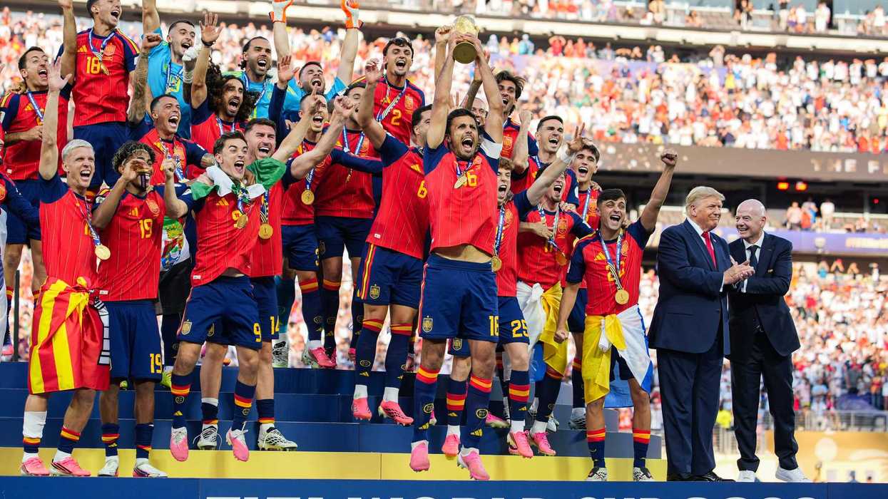 Donald Trump and Gianni Infantino on stage with the Spanish men's football team as they lift the World Cup trophy.