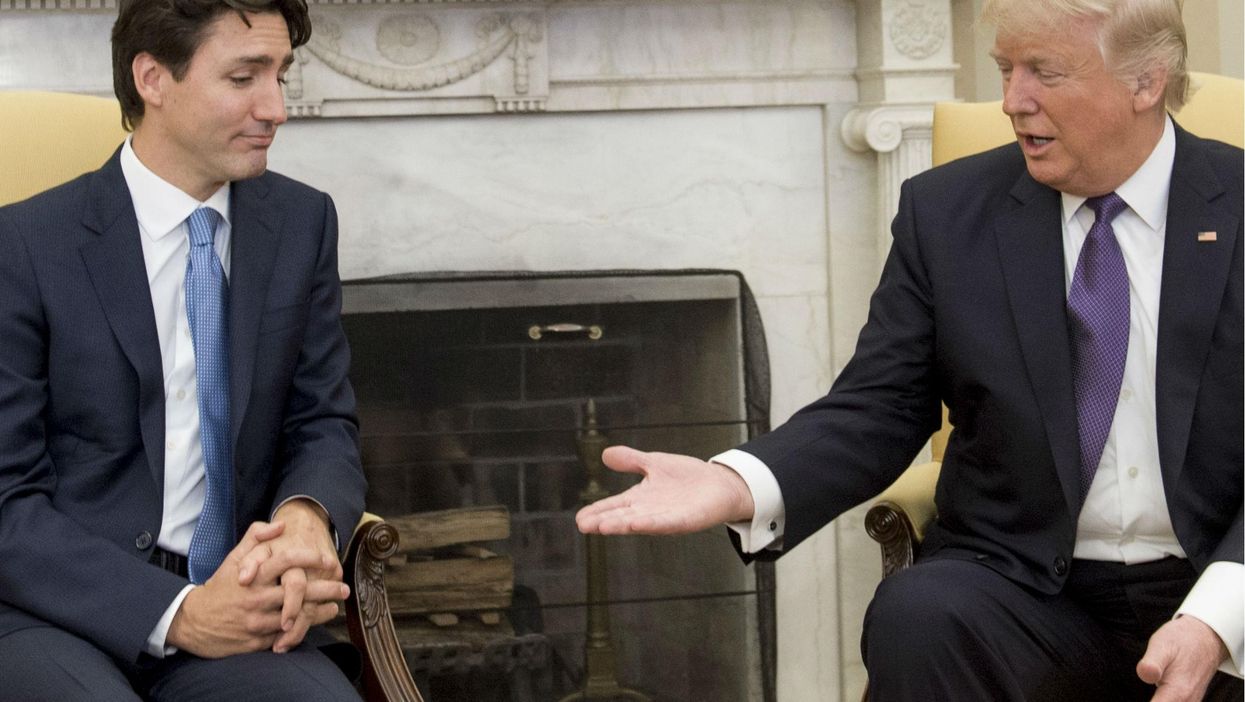 Donald Trump and Justin Trudeau shake hands during a meeting in the Oval Office of the White House in Washington, DC, on February 13, 2017