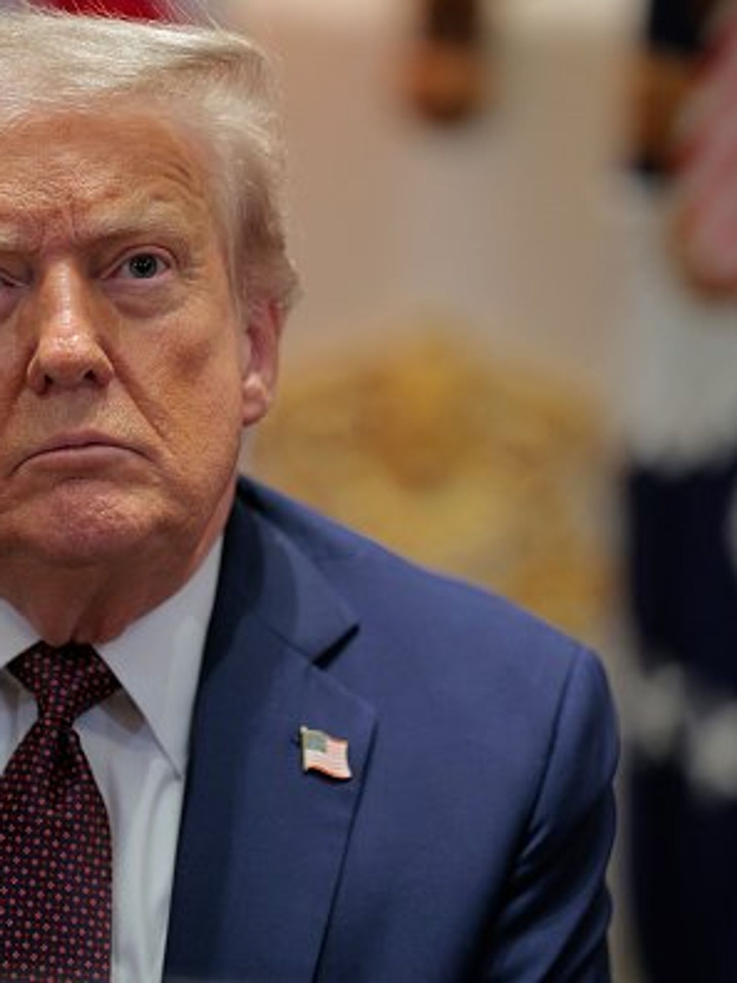 Donald Trump in a blue suit, inside the Oval Office.