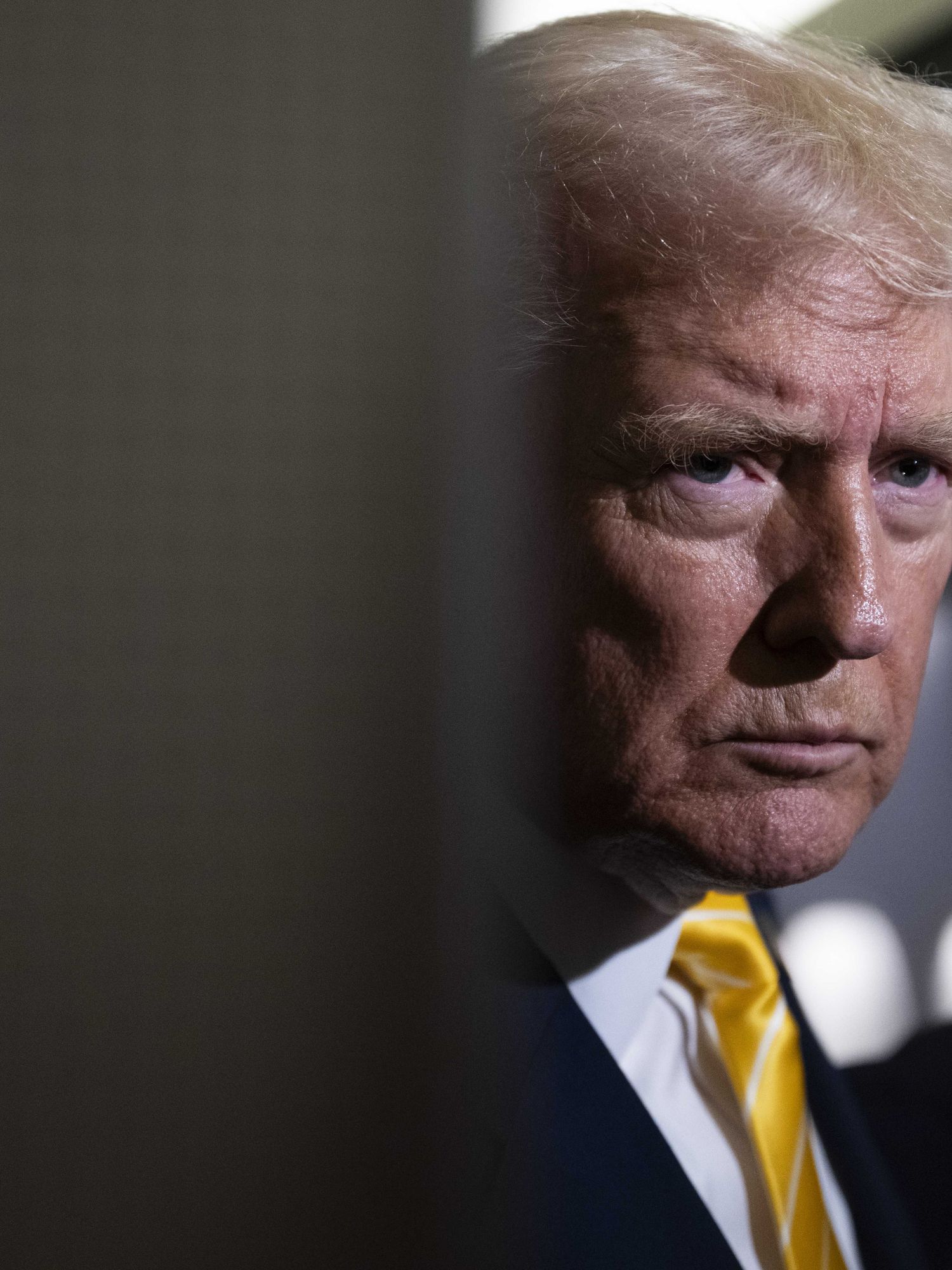 Donald Trump in the doorway inside of Air Force One, speaking to reporters.