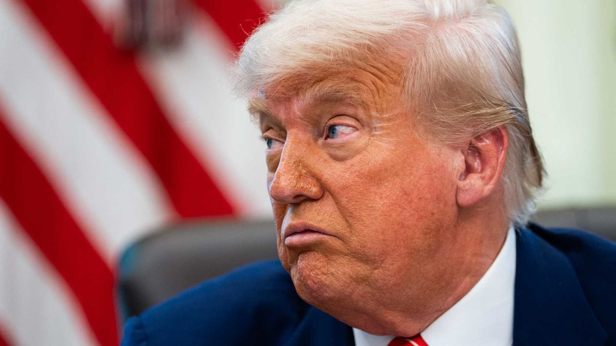 Donald Trump in the Oval Office, looking to his right.