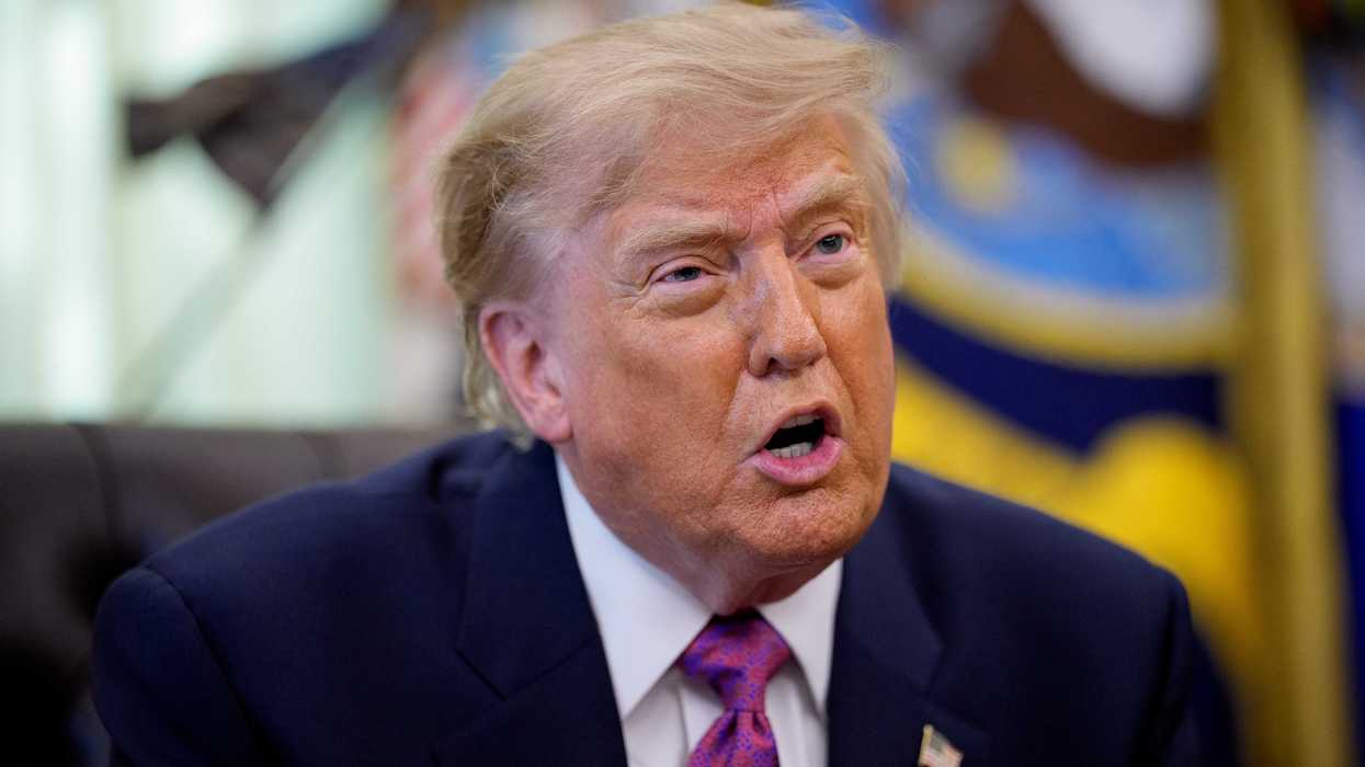 Donald Trump in the Oval Office talking to reporters.