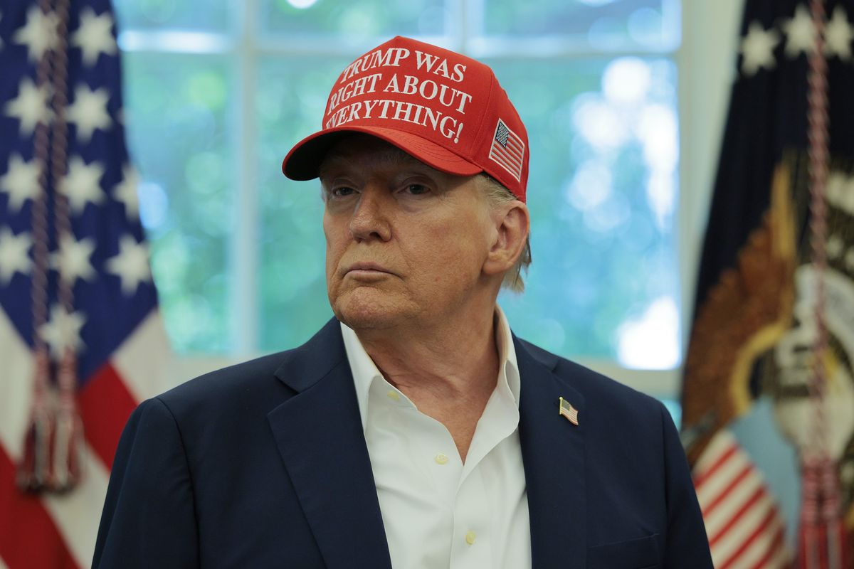 Donald Trump in the Oval Office, wearing a red cap which reads: 'Trump was right about everything!'
