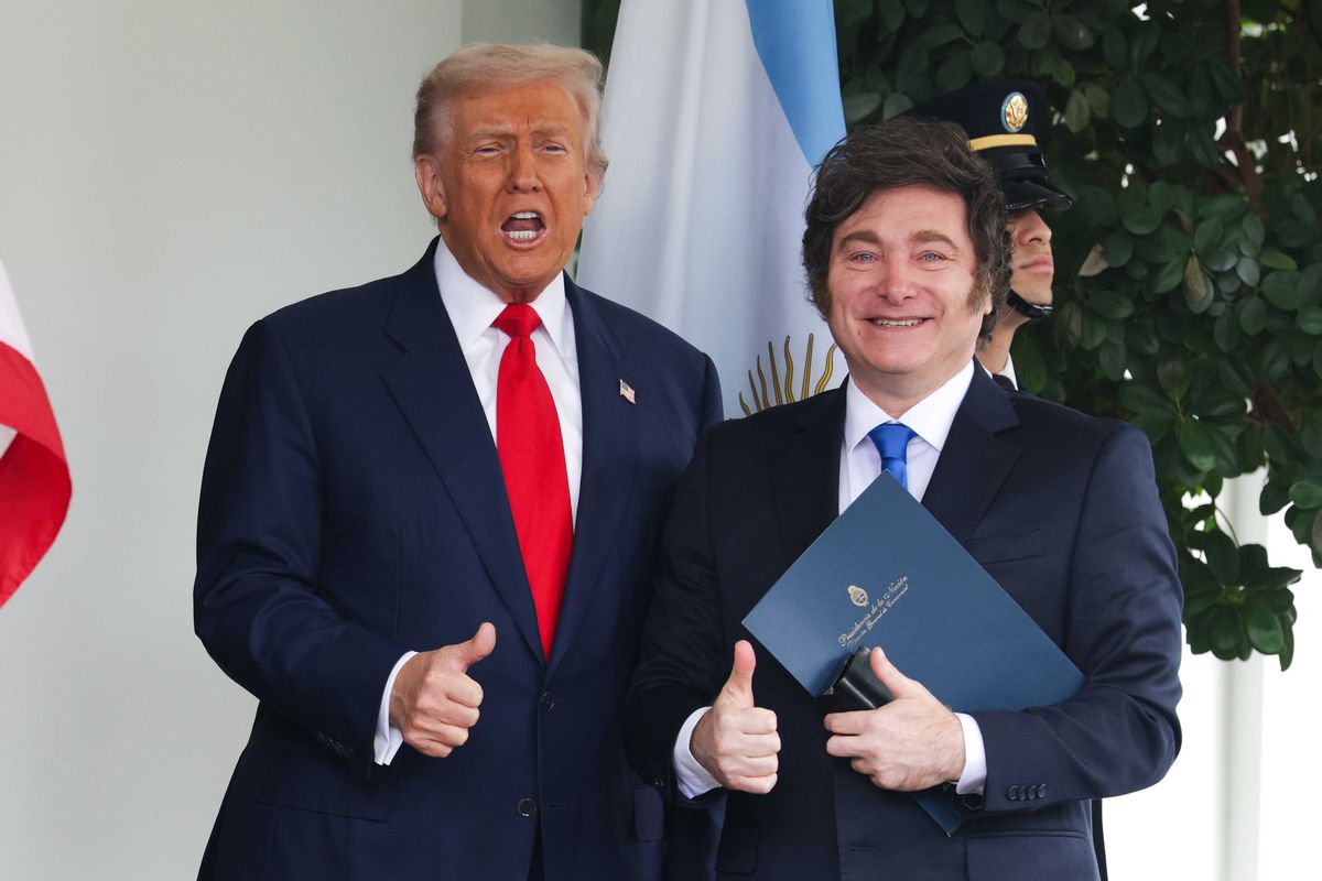 Donald Trump, left, and Javier Milei, right, gives thumbs up outside the White House, smiling. Trump is mid-speech.