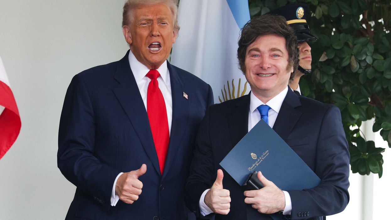Donald Trump, left, and Javier Milei, right, gives thumbs up outside the White House, smiling. Trump is mid-speech.