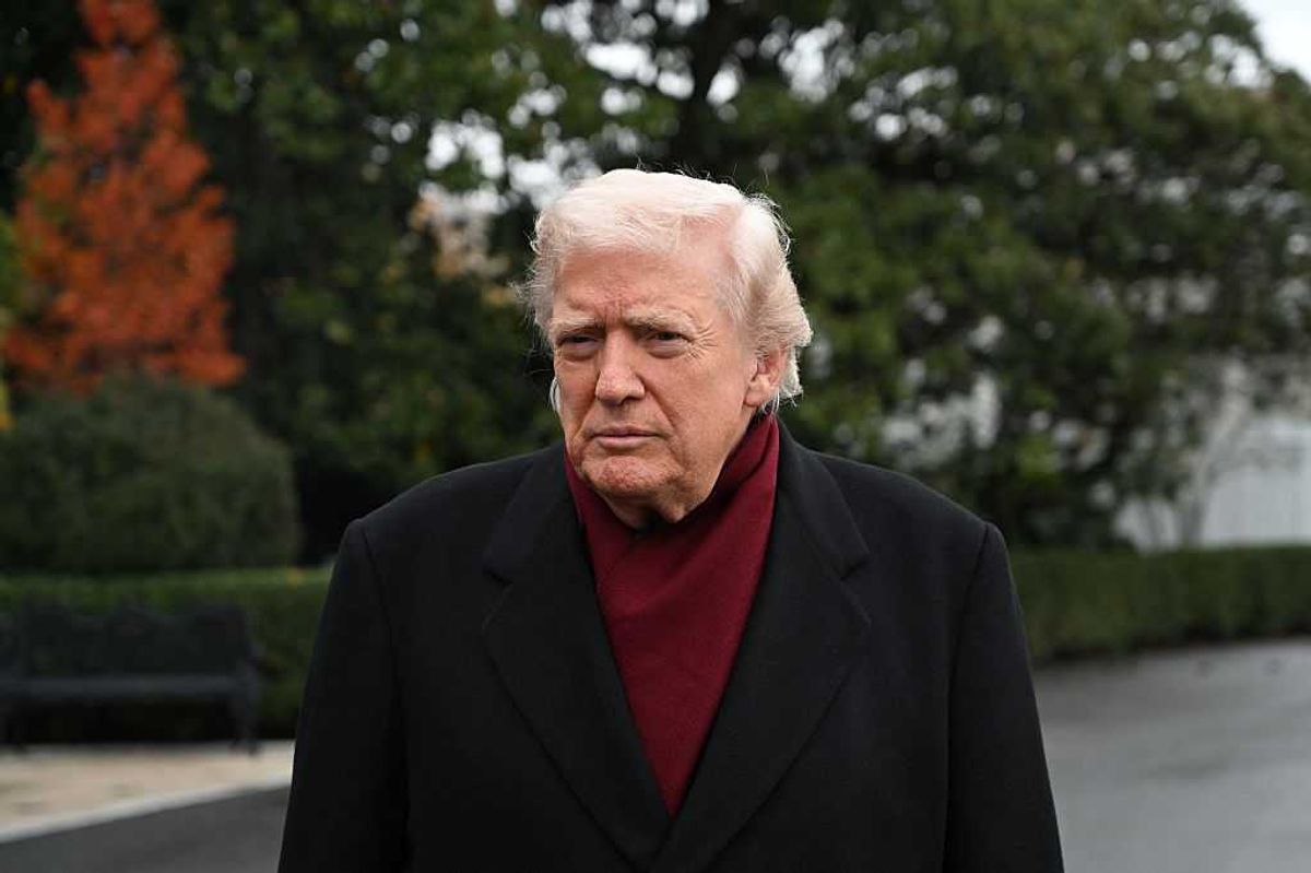 Donald Trump outside the White House, wearing burgundy underneath a black coat.