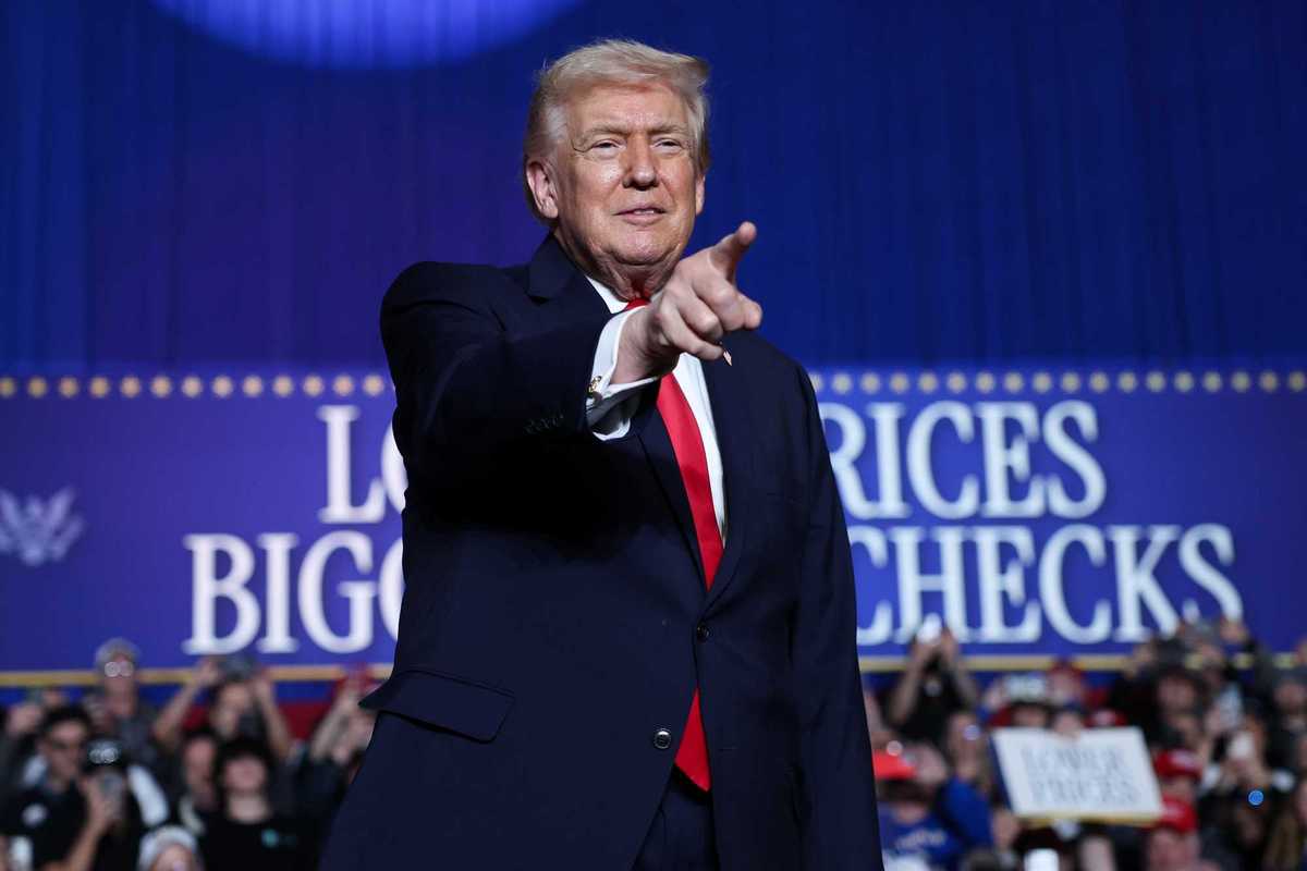 Donald Trump points at someone in the crowd at a rally.