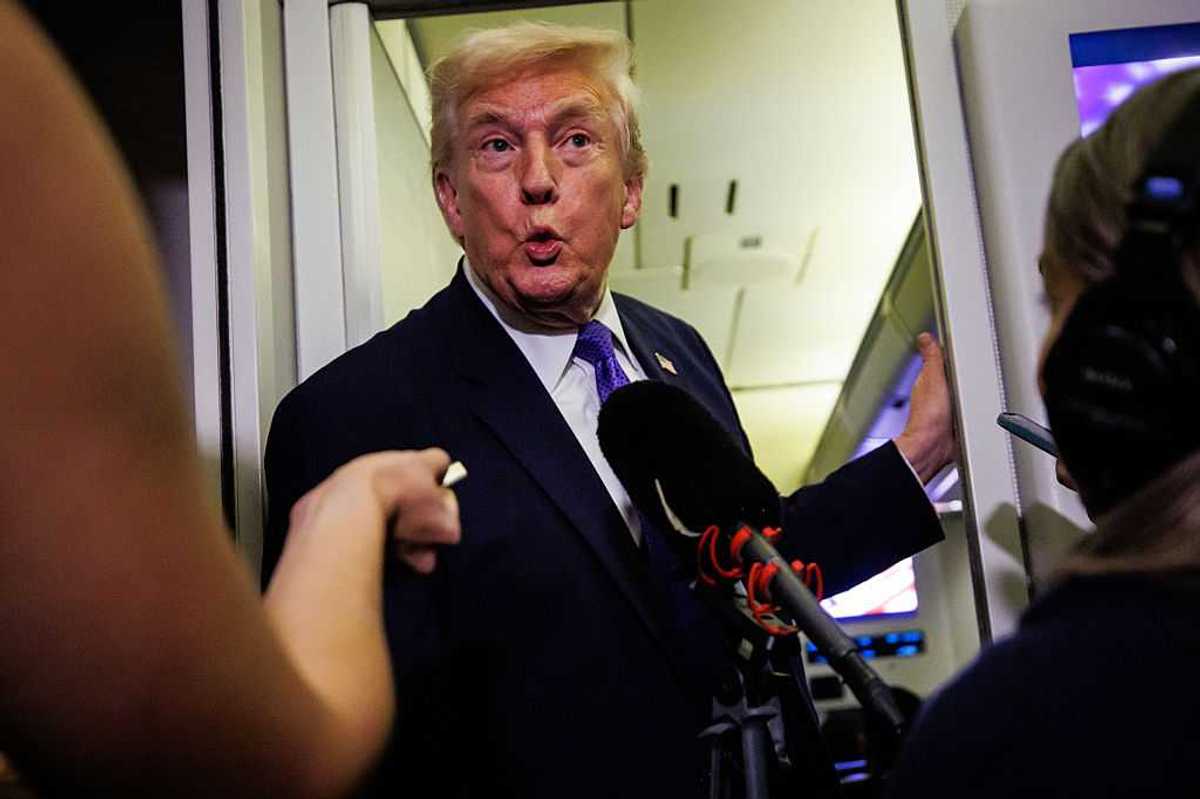 Donald Trump purses his lips in shock as he is interviewed by reporters on board Air Force One.