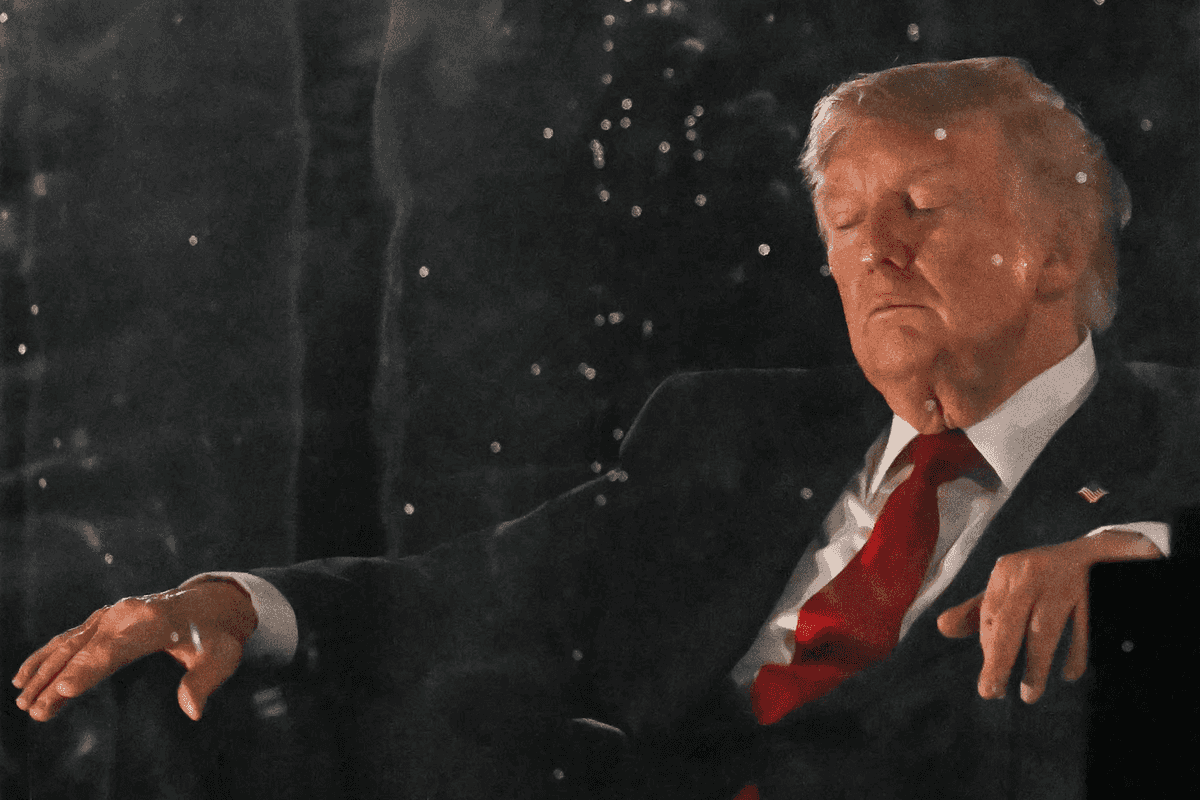 Donald Trump sitting in a chair with his eyes closed at July 4 celebrations at the National Mall.