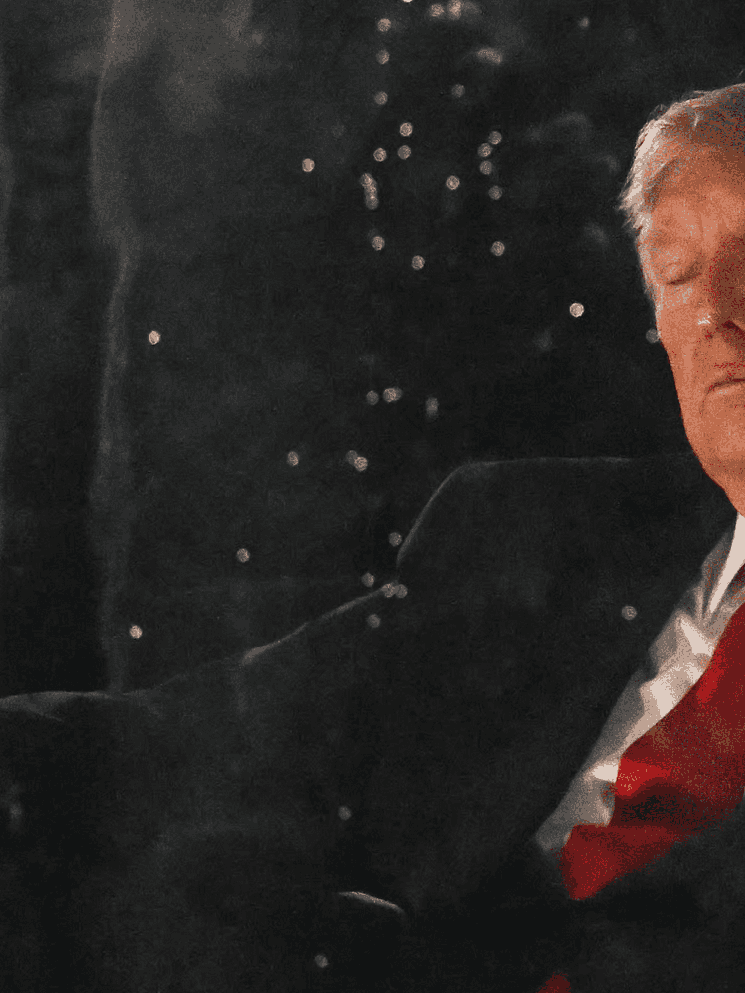 Donald Trump sitting in a chair with his eyes closed at July 4 celebrations at the National Mall.