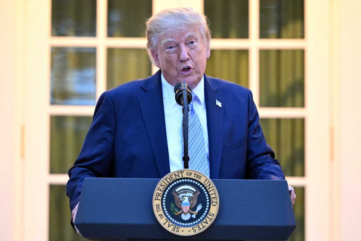 Donald Trump speaking behind his presidential lectern in the Rose Garden.