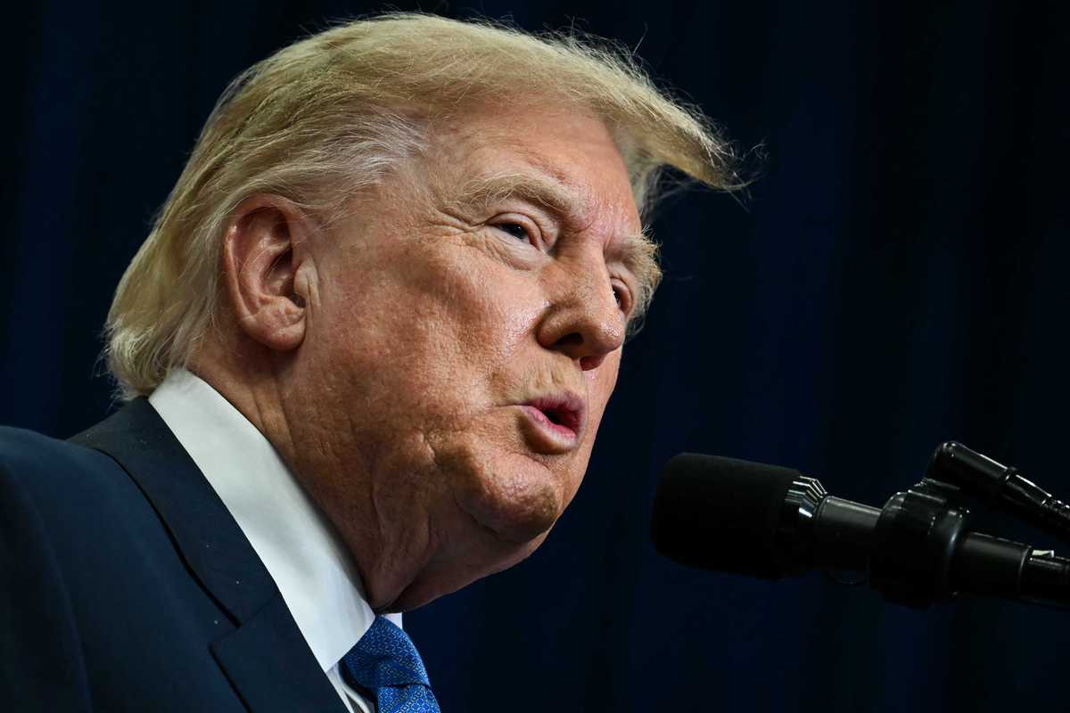 Donald Trump speaking into a microphone while delivering a speech.