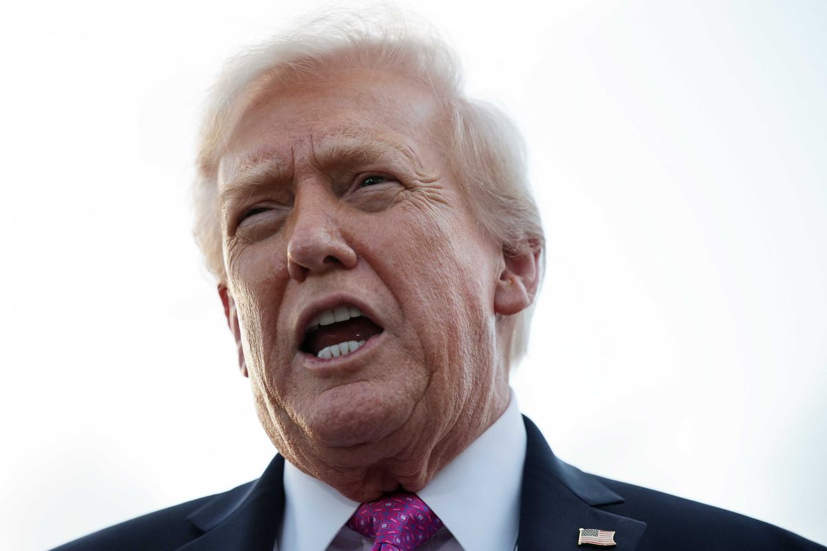 Donald Trump speaking outside against a bright white sky.