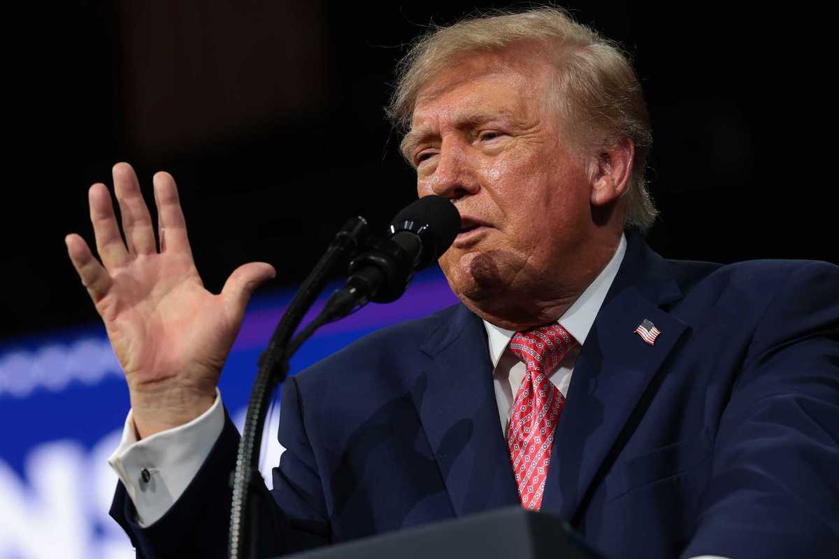 Donald Trump speaks behind a lectern and microphone at a rally in Kansas.