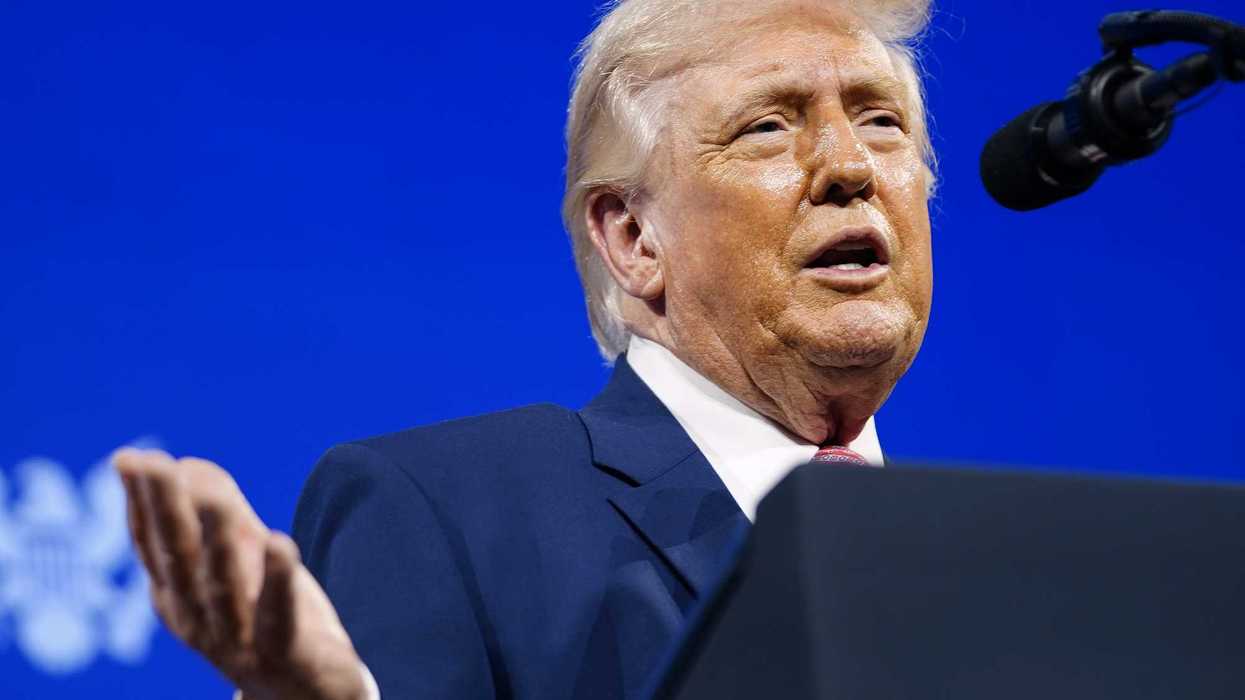 Donald Trump speaks behind a lectern at the Future Investment Initiative summit in Miami.