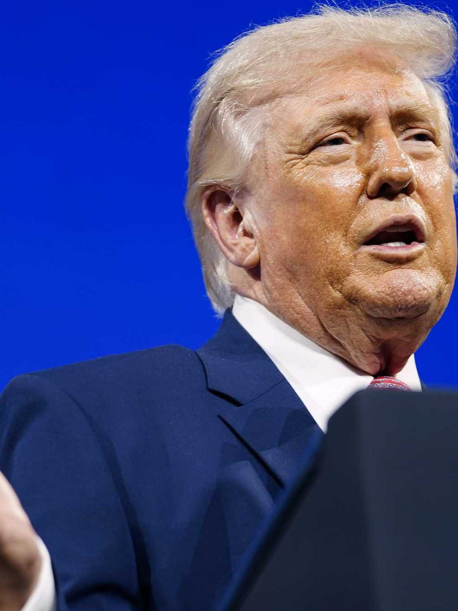 Donald Trump speaks behind a lectern at the Future Investment Initiative summit in Miami.
