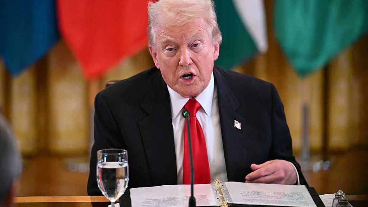 Donald Trump speaks in front of a dinner table during a dinner with Central Asian countries.