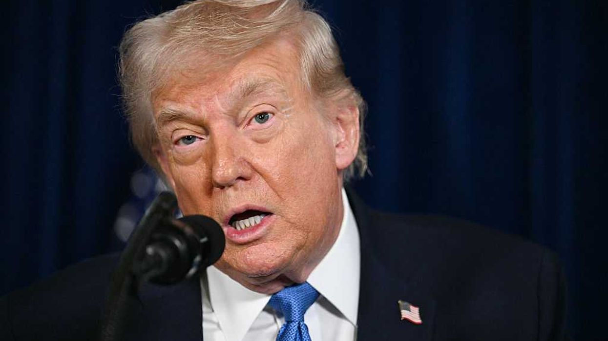 Donald Trump speaks into a microphone during a press conference on Venezuela.