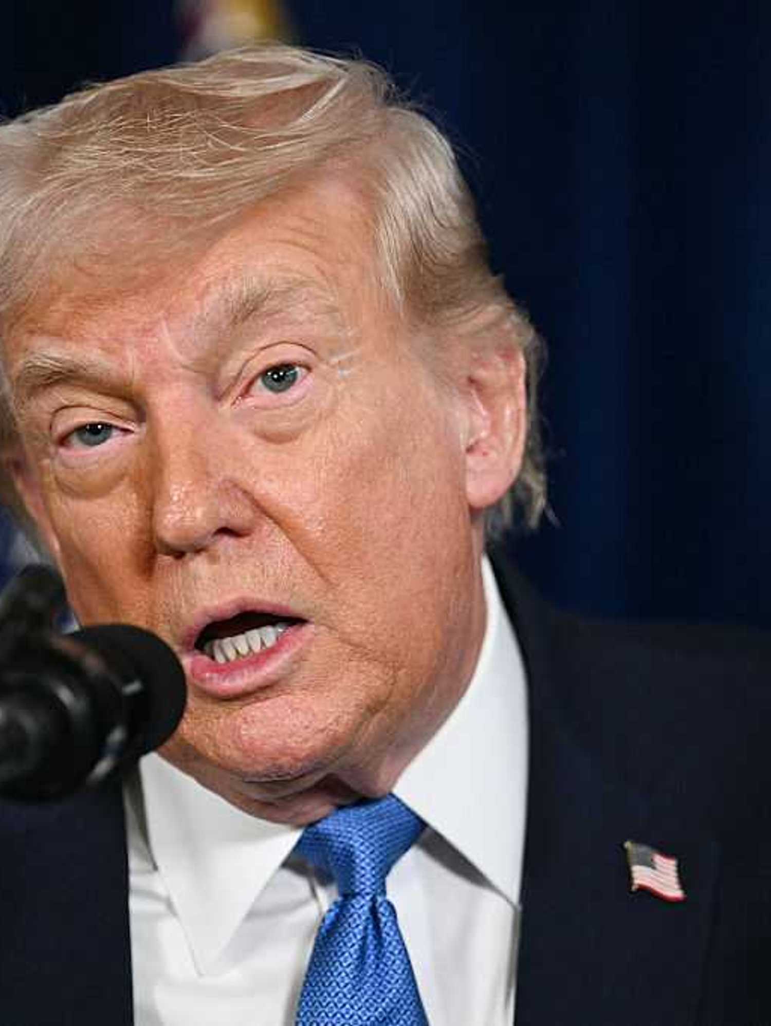 Donald Trump speaks into a microphone during a press conference on Venezuela.