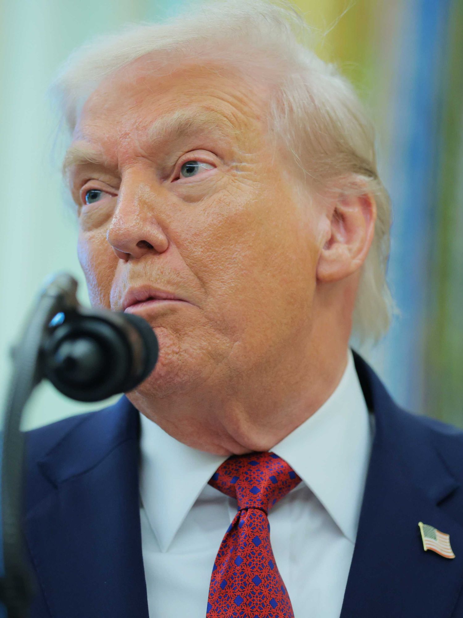 Donald Trump speaks into a microphone during a White House press conference.