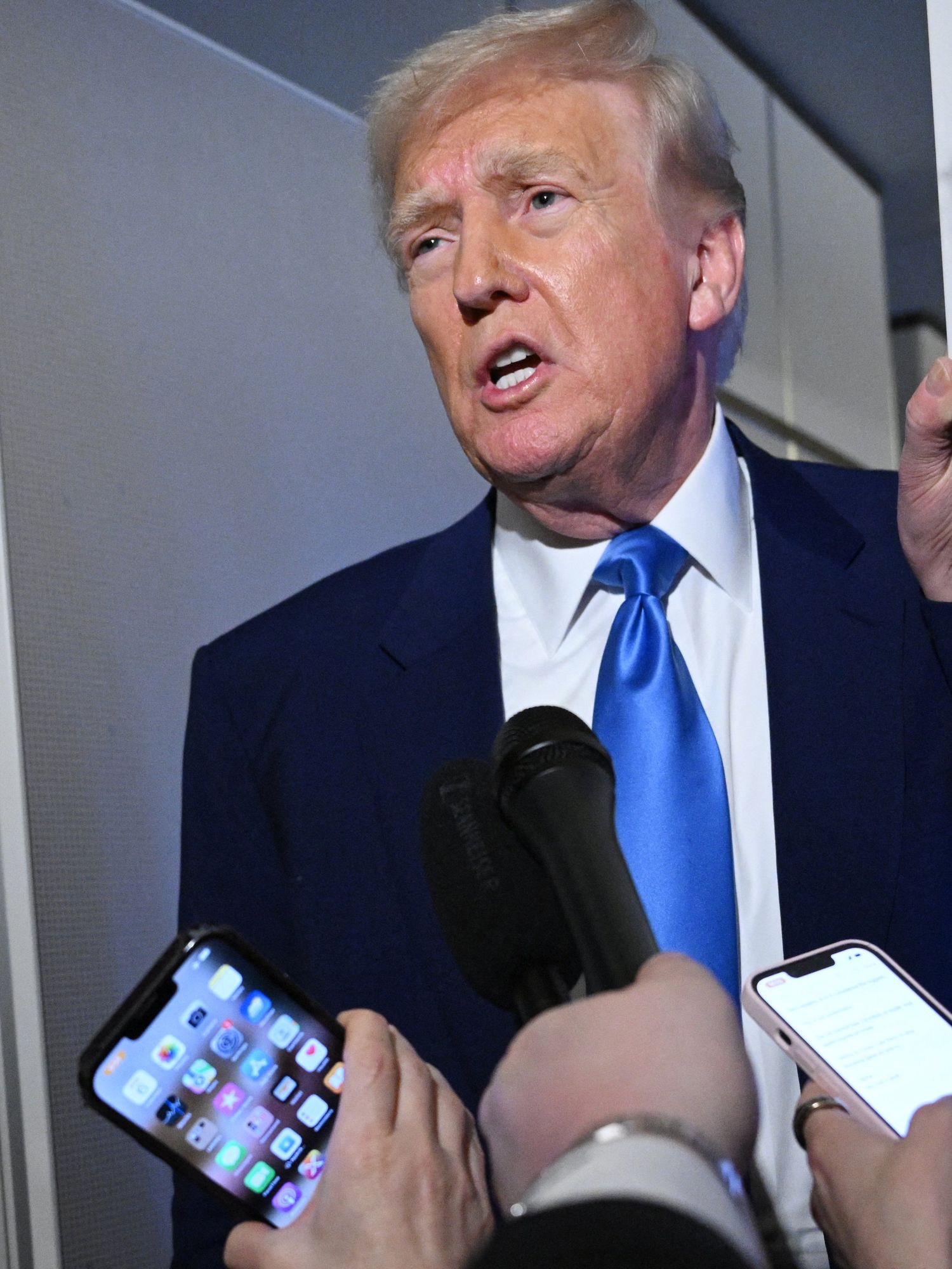 Donald Trump speaks to reporters in Air Force One.