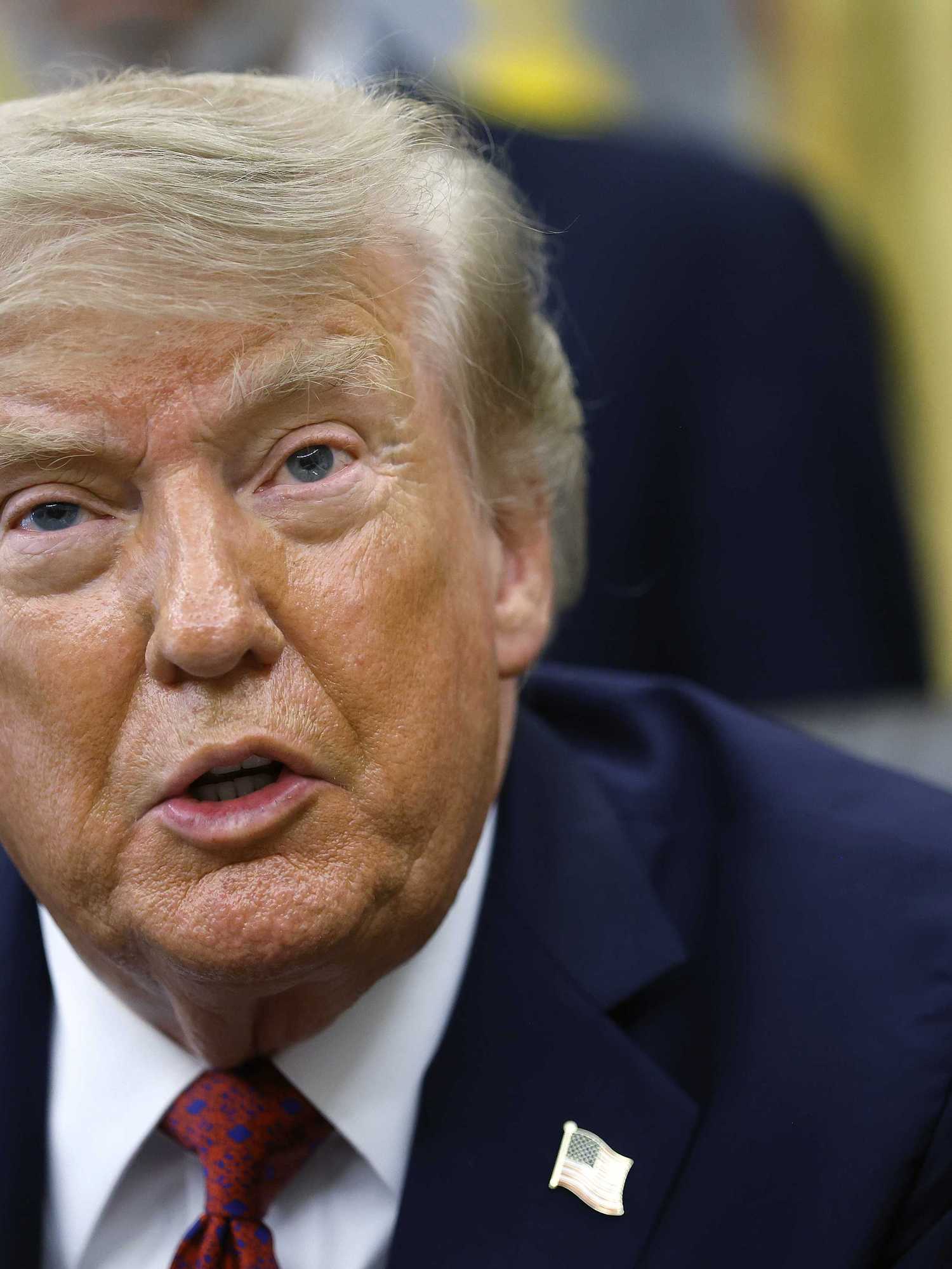 Donald Trump speaks to reporters in the Oval Office.