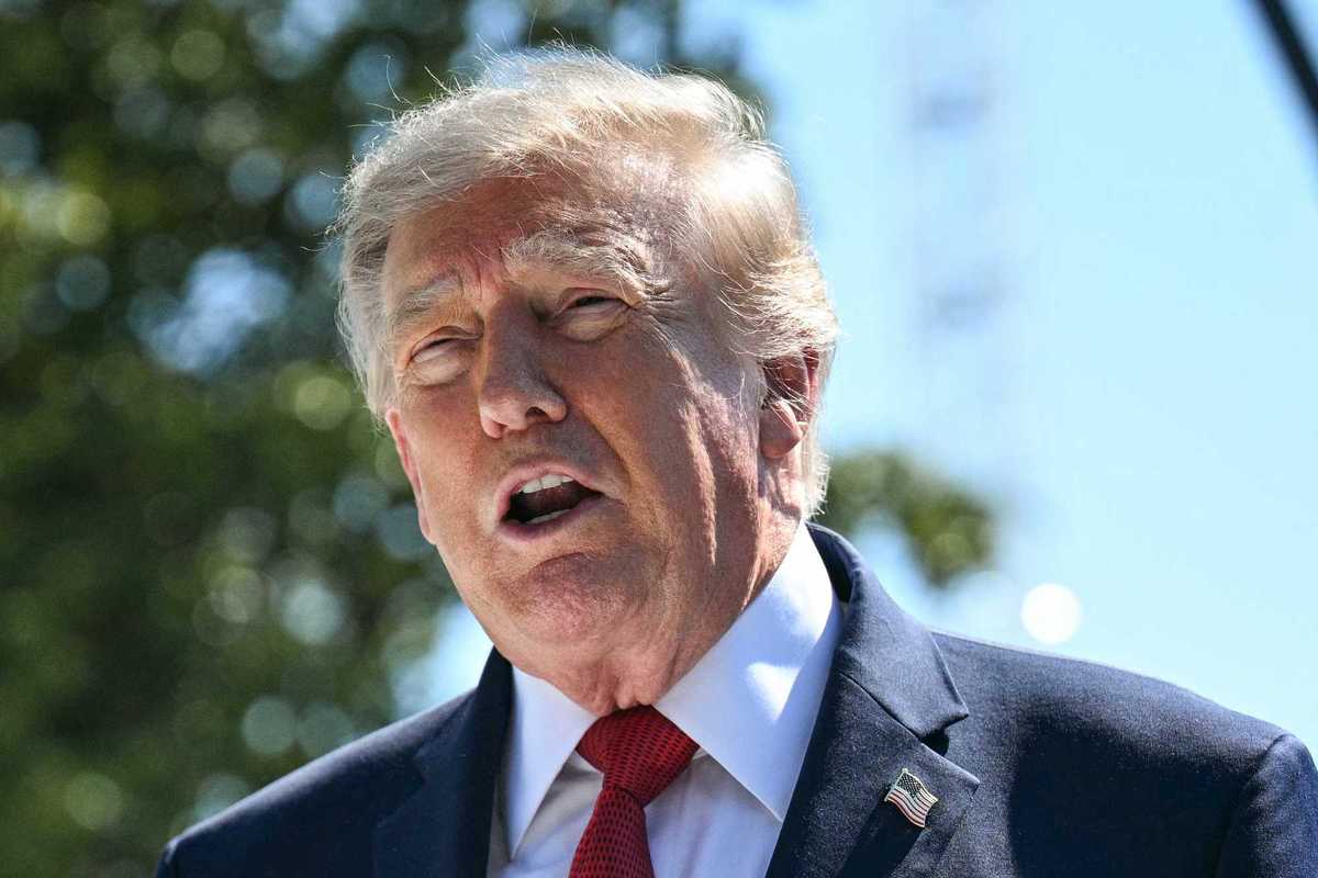 Donald Trump speaks to reporters outside the White House.