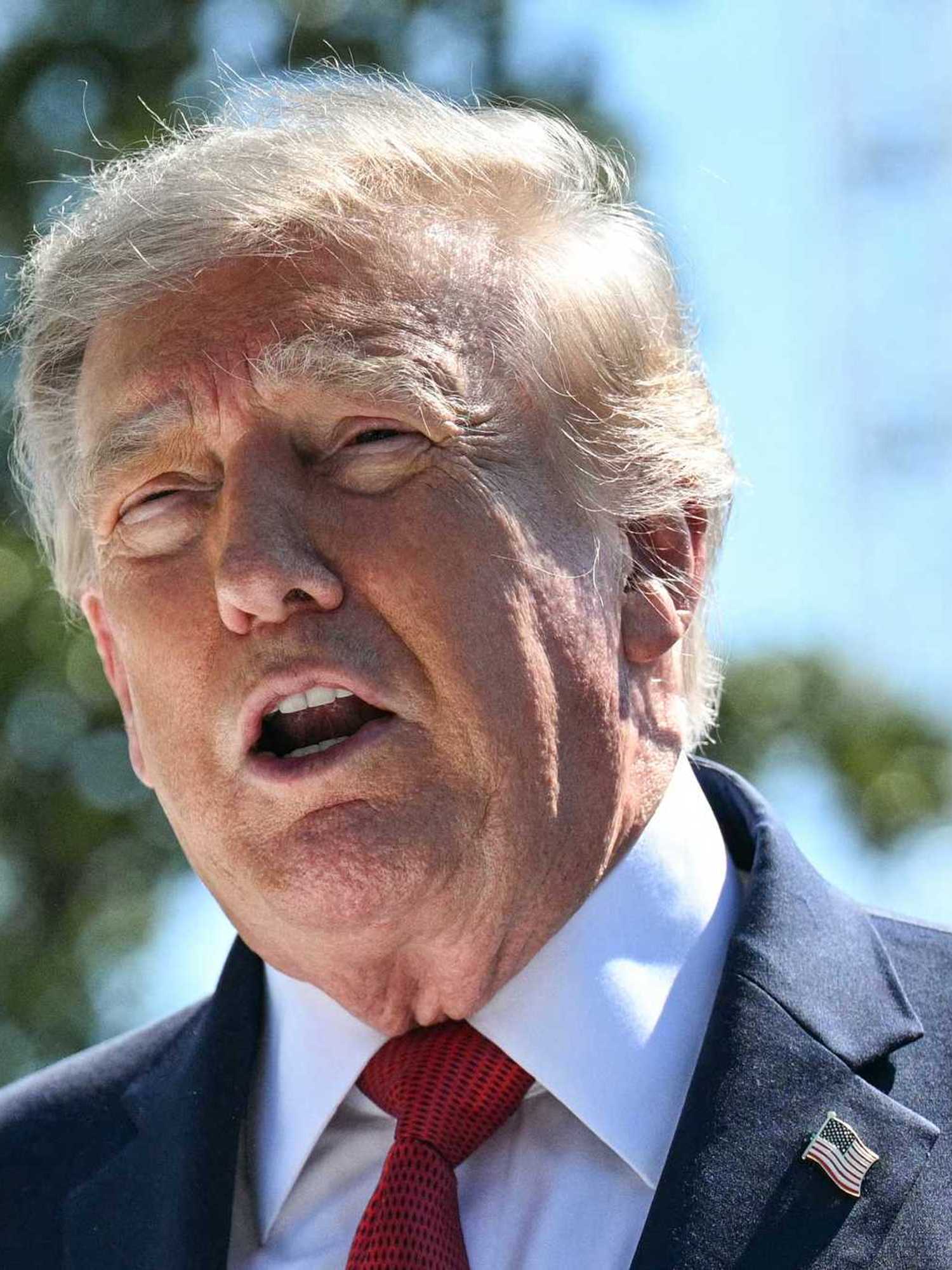 Donald Trump speaks to reporters outside the White House.