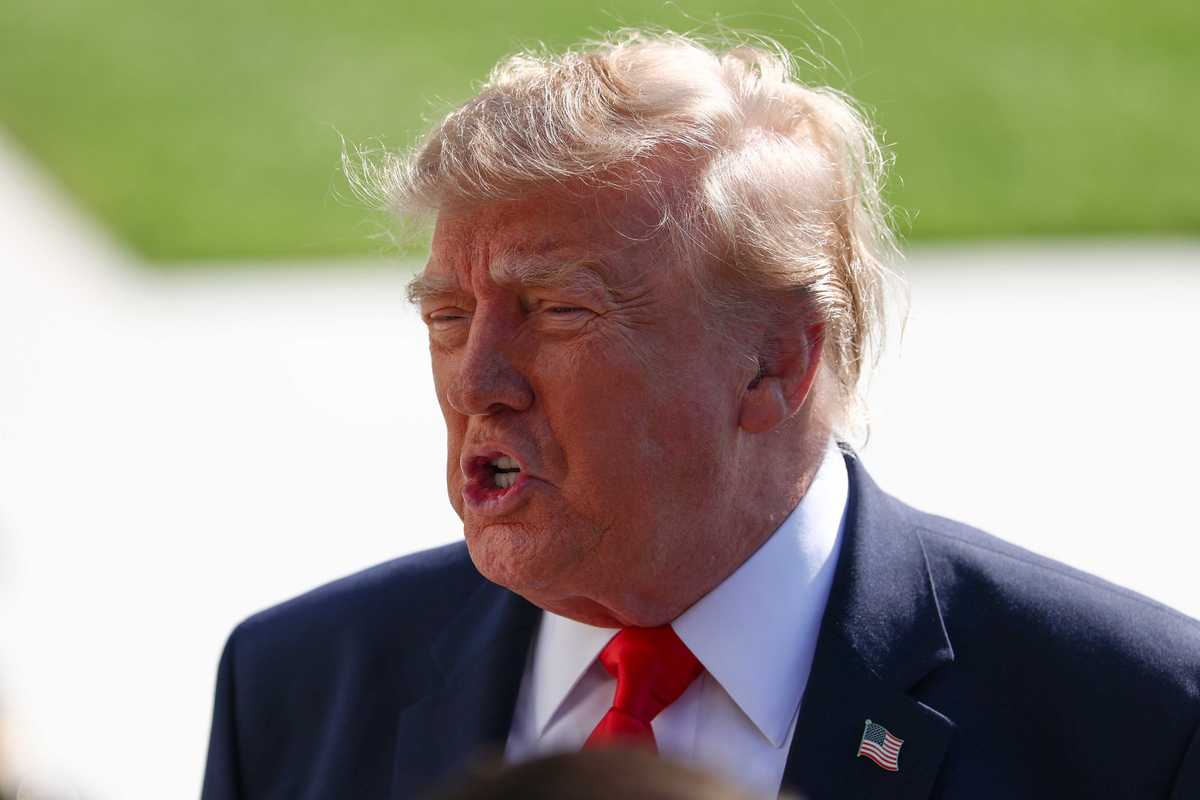 Donald Trump speaks to reporters outside the White House.