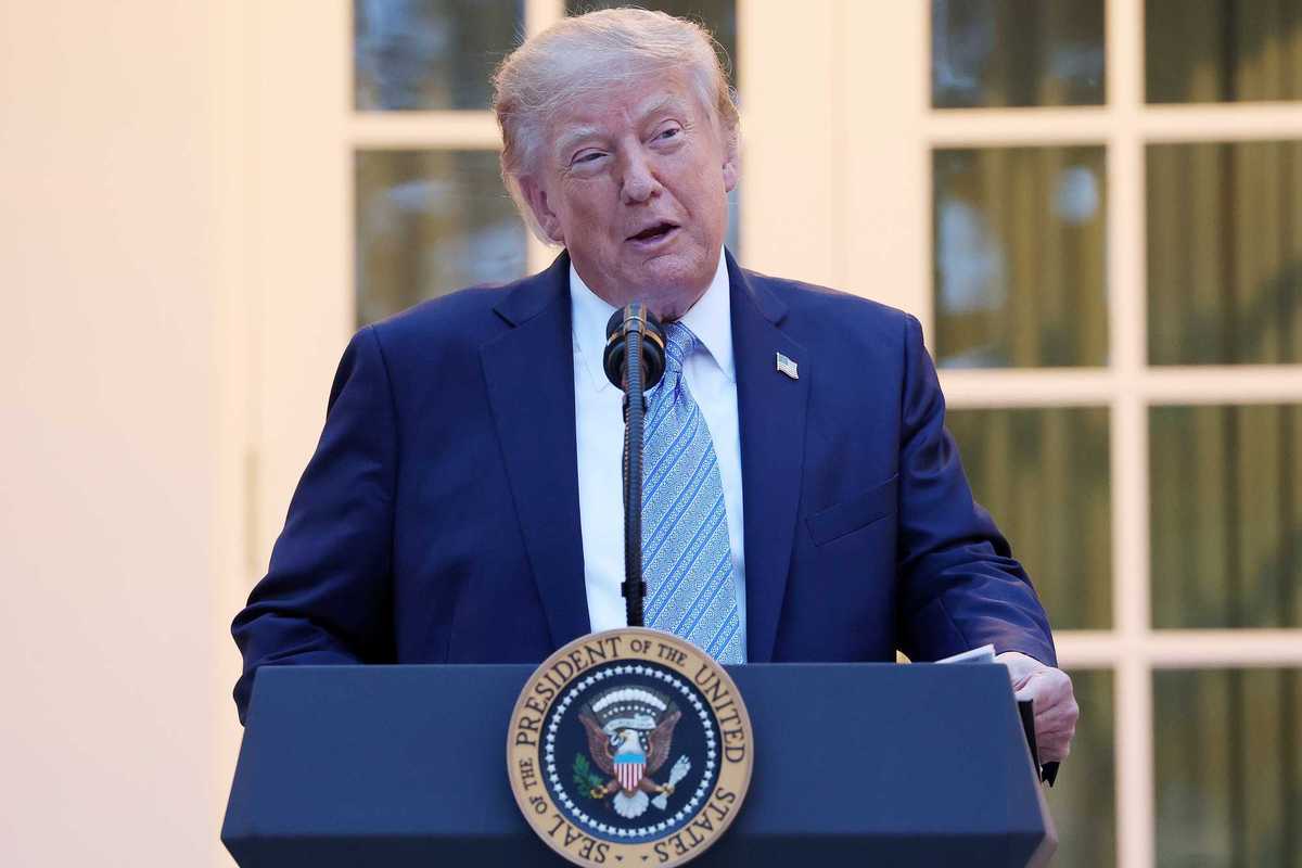 Donald Trump standing and speaking behind his presidential lectern in the Rose Garden.