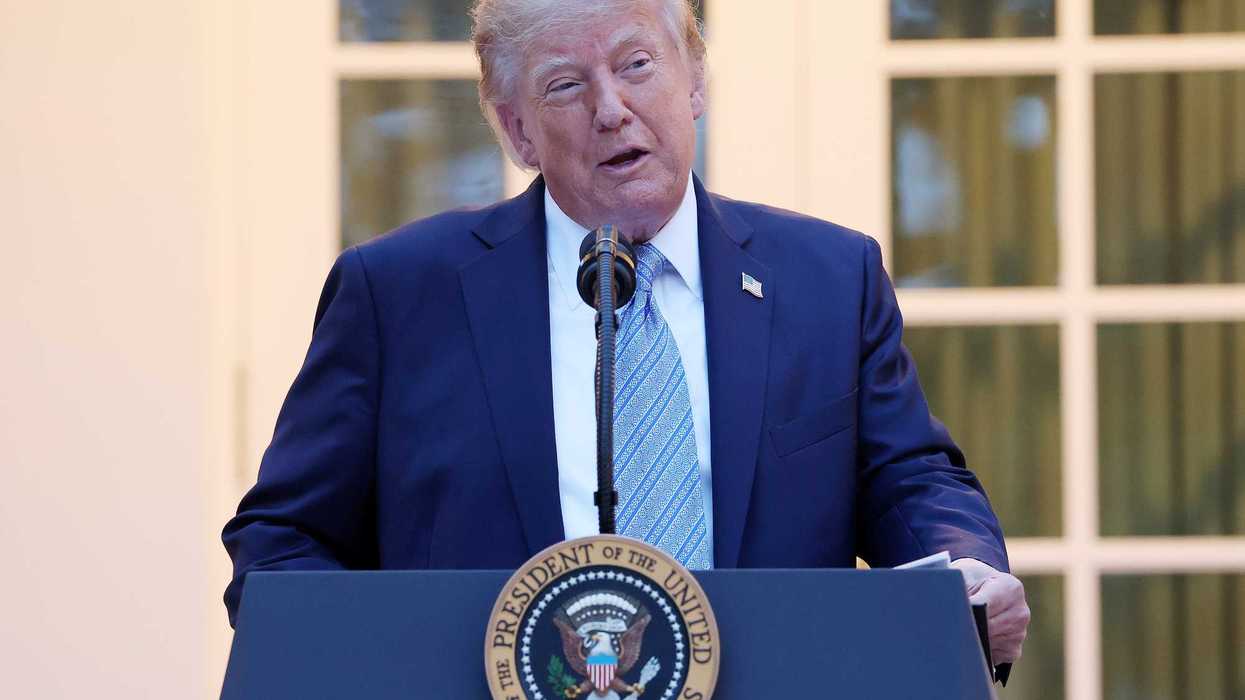 Donald Trump standing and speaking behind his presidential lectern in the Rose Garden.