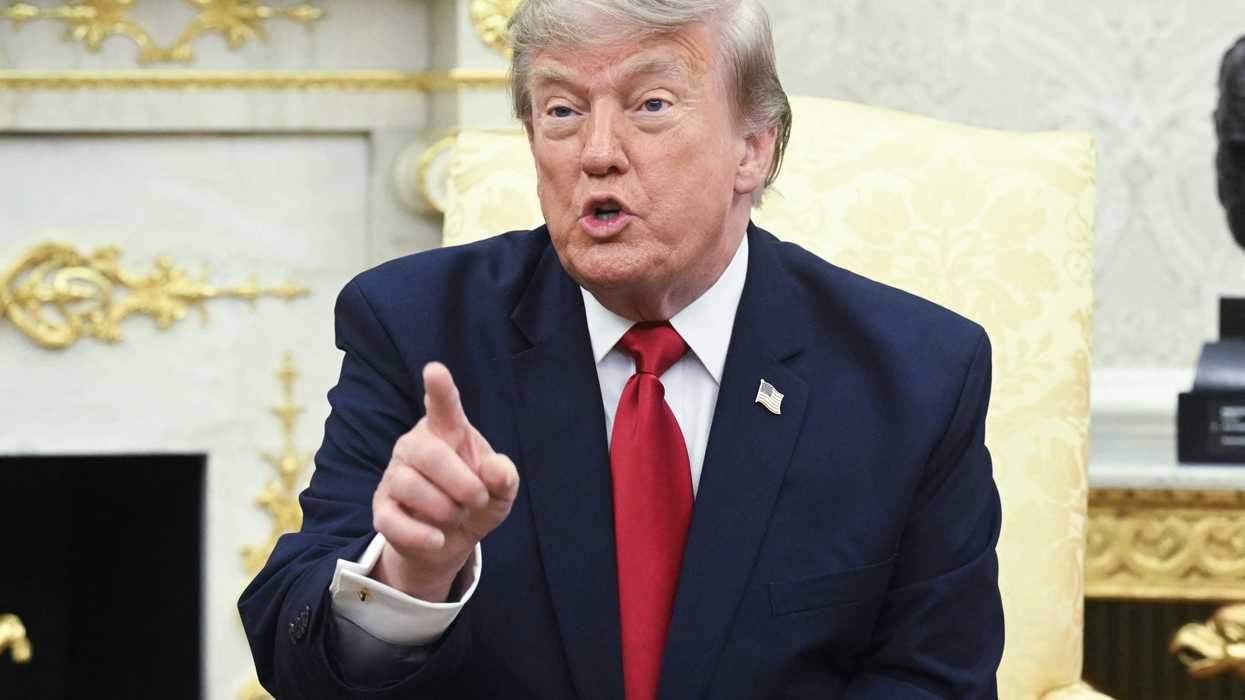 Donald Trump talking to reporters inside the Oval Office.